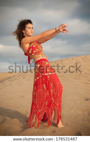 sexy woman belly dancer arabian in desert dunes