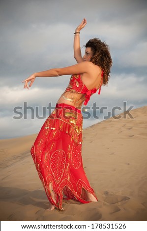 sexy woman belly dancer arabian in desert dunes