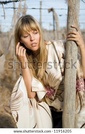Blond girl searching something in a field