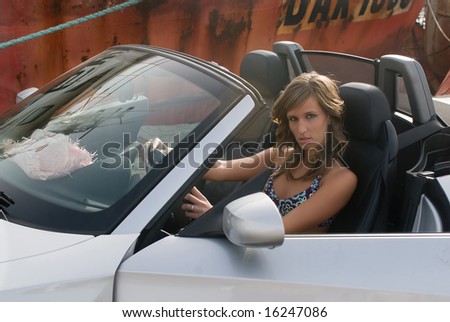 woman in an sport car in the docks