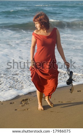 alone woman walking in the seaside
