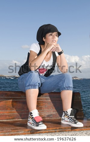 woman in the adolescence sitting near the sea