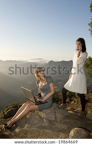 women working with laptop in the mountain and talking by phone