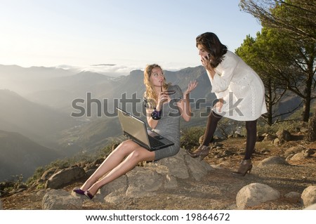 women working with laptop in the mountain and talking by phone