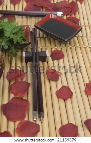 pair of chinese sticks to eat with on bamboo and roses