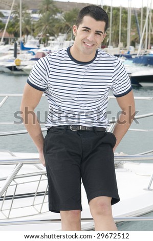 beautiful sailorman wearing sailor clothes in a yatch