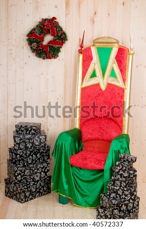 santa claus armchair in his little wood house with presents