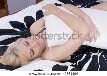 sensual blonde woman on a bed