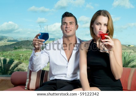 man and woman with cocktails