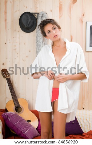 Woman in her wood house dressing