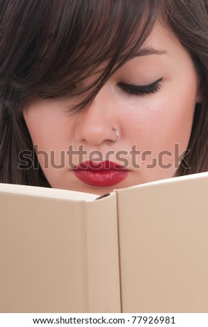 beautiful woman reading a book in her bed