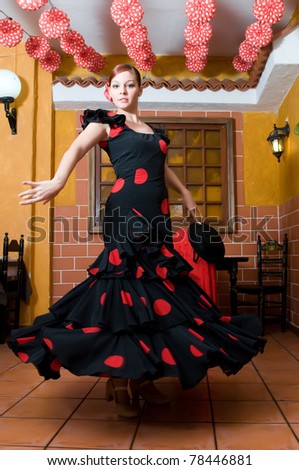 women in traditional flamenco dresses dance during the Feria de Abril on April