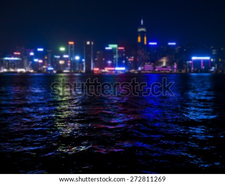 view of skyscrappers  shining with colourful lights in Hong Kong bay at night