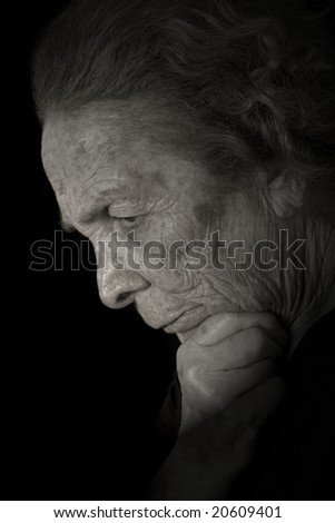Black and white portrait of a elderly woman thinking.
