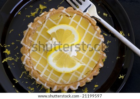 Single lemon tart photographed from above.