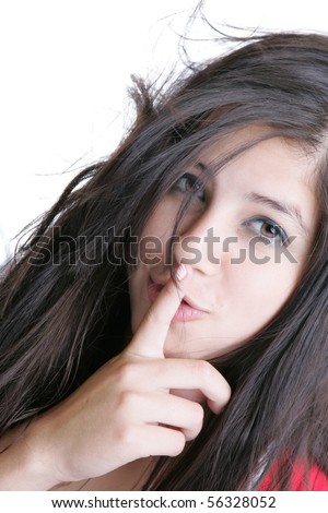 Closeup of a beautiful young woman gesturing to be quiet