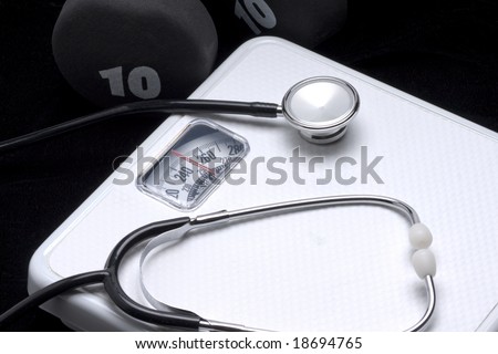 Scale, stethoscope and dumbbell as symbols of health and fitness.