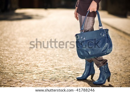 Young woman with blue handbag and shoes