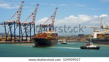 container vessel and a small ship, no logos on the photo leaving the port of Durban South Africa