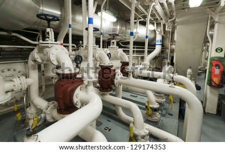 Industrial valves, pipes in ship\'s engine room