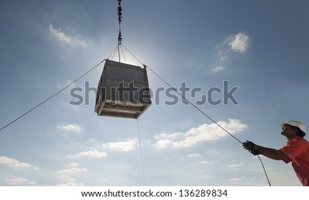 crane lifting operations - men attending tag lines