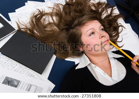 Portrait of a natural young woman when taking a break while learning studying with pencil in mouth