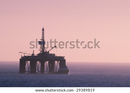 oil rig and offshore vessel at the sunset
