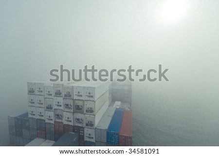 large container vessel ship going through fog, no logos in this picture