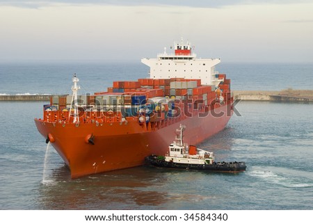 container vessel and a small ship, no logos on the photo