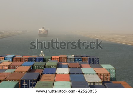 large container vessel ship passing suez canal in the sand storm