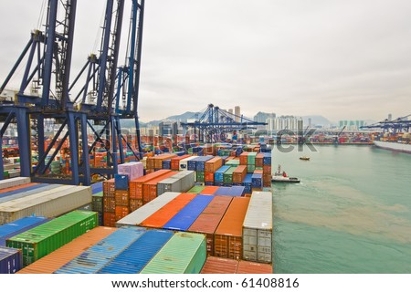 container vessel and a small tug boat - mooring operations in Hong Kong