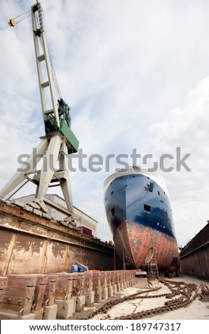 A ship in a dock in Denmark, Frederikshavn - xbow type offshore design with a large crane