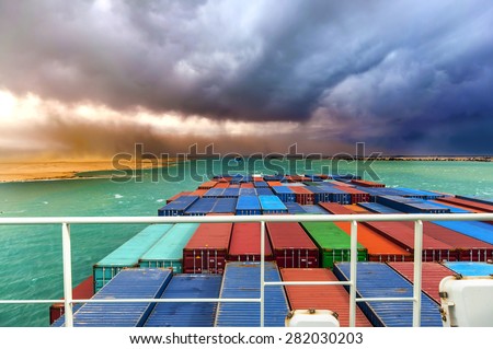 Desert Storm in SUEZ CANAL, Egypt. Container cargo ships going through the canal.