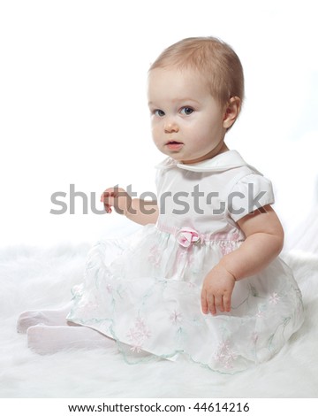 Innocent baby portrait dressed in white in high key.