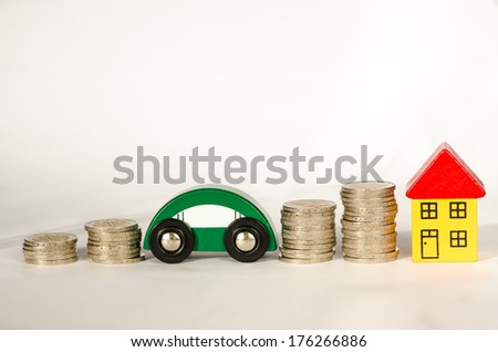 pile of coins, house and car detail image