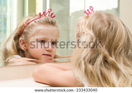 beautiful blond girl  reflection in the mirror