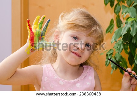 blond girl with colorful painted hand