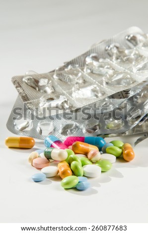 group of pills and silver empty pills blister isolated