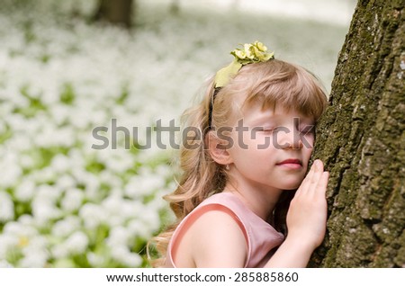 adorable blond girl princess dreaming in woods