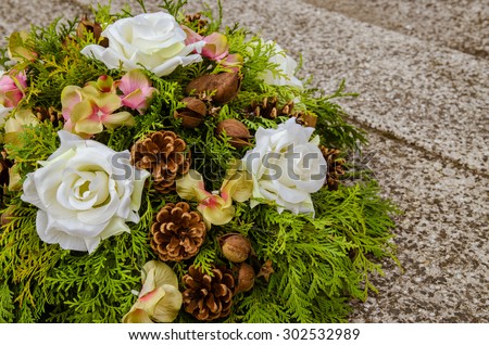 floral wreath decoration lying on the grave