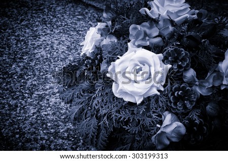 floral wreath decoration lying on the grave