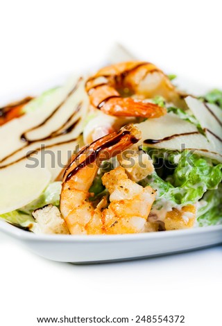 Salad with shrimp and avocado on white.