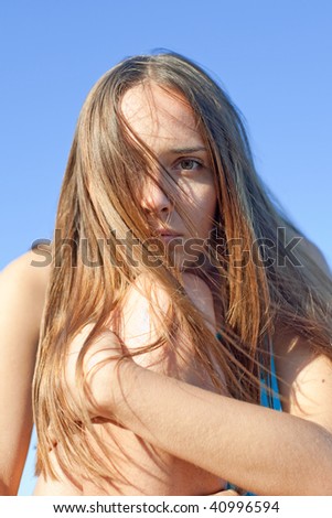 Portrait of young long-haired brunette woman outdoor