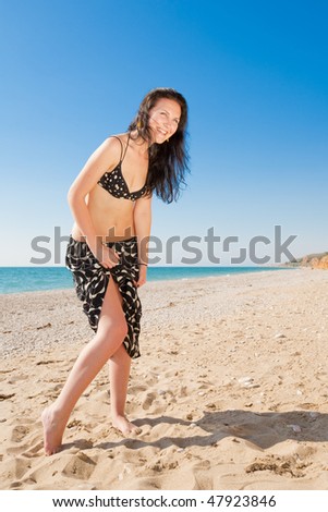 Attractive girl in black skirt at the sea