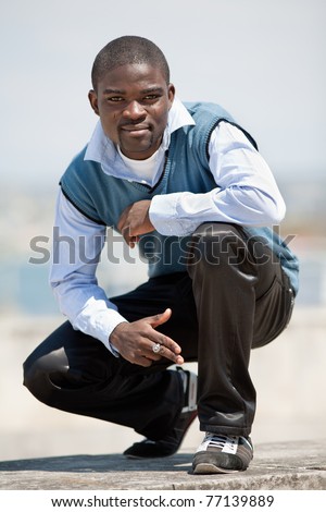 Young black man on open air. Guy posing outdoors