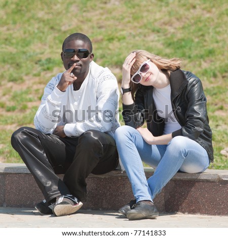 White Girl And Black Guy Outdoors. Young Man And Woman Sitting In The ...