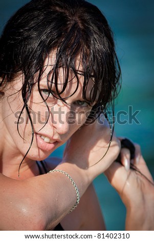 Portrait of attractive young woman with wet hair. Brunette looking at camera