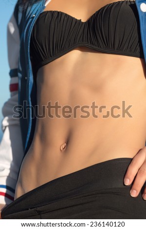 Woman\'s torso. Body parts. Abdominal press of attractive tanned woman