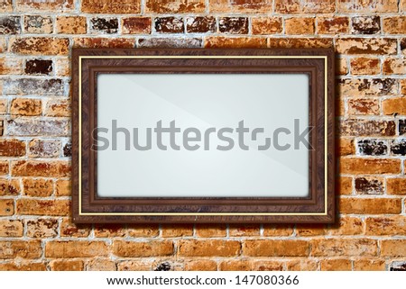 Empty frame on old brick wall