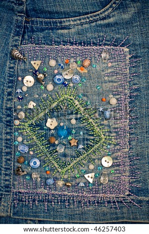 Handmade embroidery with buttons on the blue jeans
